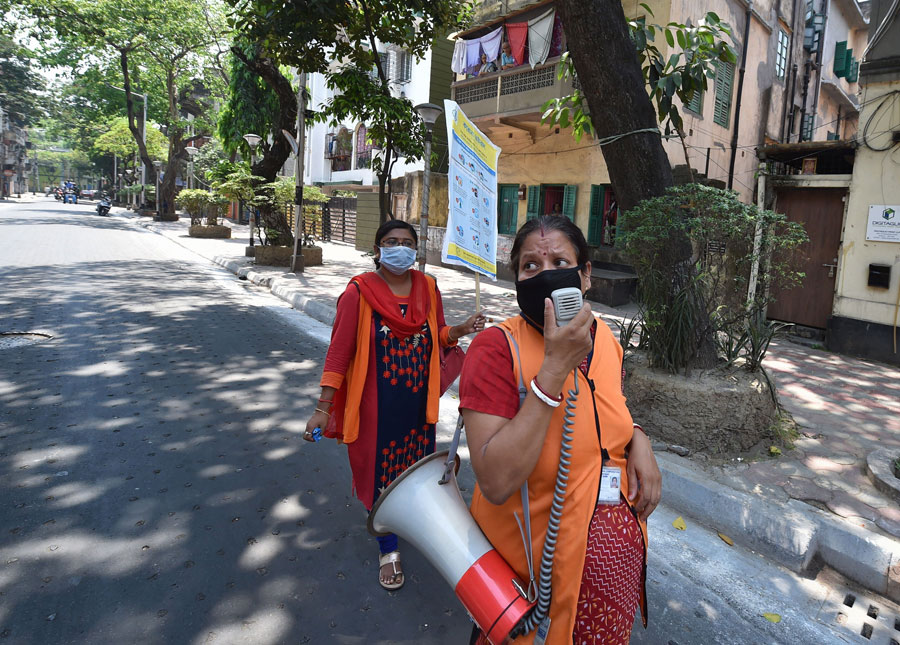 Health workers announce on a loudspeaker to make people aware of the novel coronavirus and appeal to them to stay home during nationwide lockdown imposed in the wake of coronavirus pandemic, on International Health Day in Calcutta on Tuesday