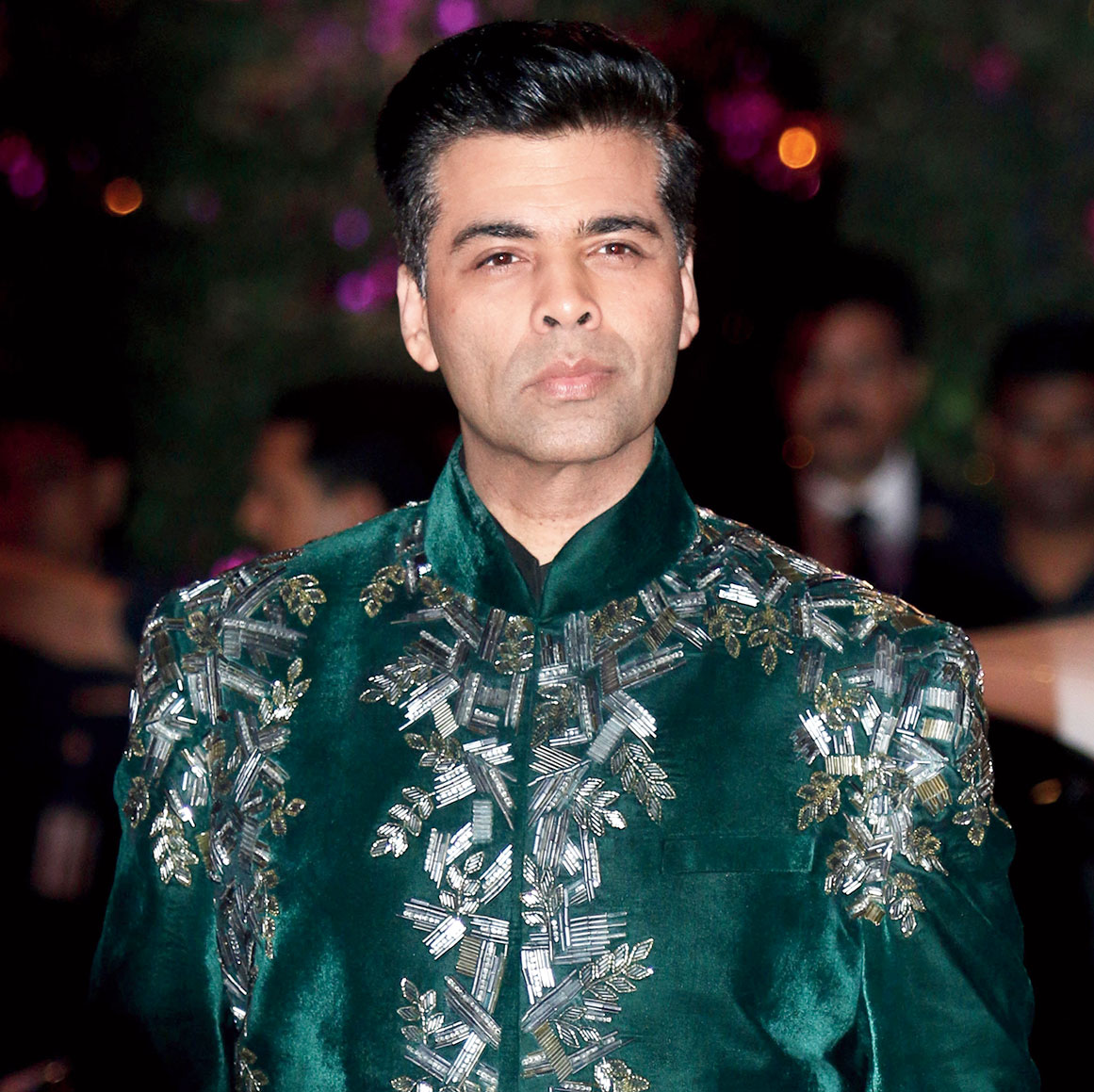 Karan Johar looooves clothes that are making a statement. He likes colours, heavy shoes and he enjoys himself! I feel he is the only director who kind of manages that style and flamboyance