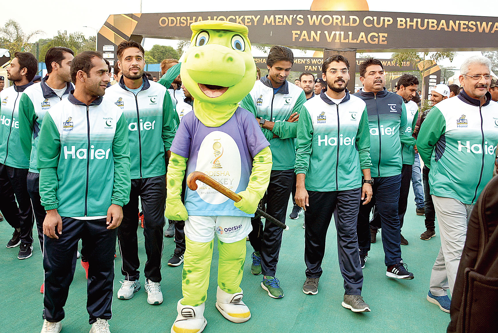 Pakistan team members pose with Olly, the mascot for sport events in Odisha, at Fan Village in Bhubaneswar on Monday.