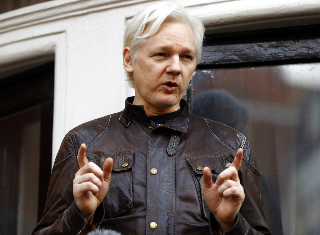 In this May 19, 2017, photo, WikiLeaks founder Julian Assange gestures to supporters outside the Ecuadorian embassy in London.