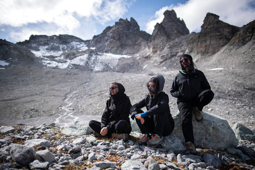 Activists in dark clothing wearing mourning veils during a commemoration near the 'dying' glacier of Pizol mountain in Wangs, Switzerland, on Sunday