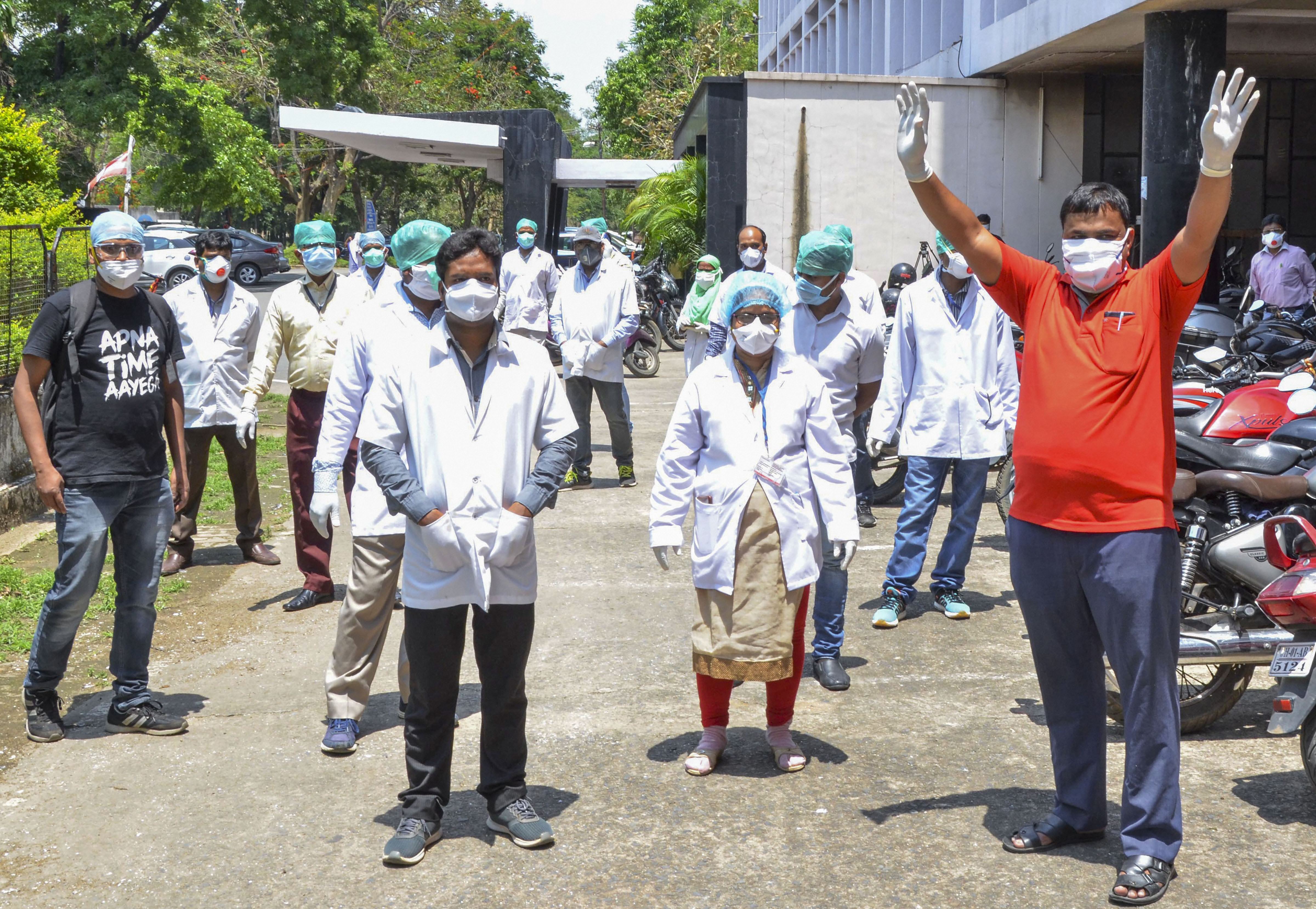 Lab technicians and nurses come out of Rajendra Institute of Medical Sciences (RIMS) after a COVID-19 positive case was detected at the hospital, in Ranchi, Friday, May 1, 2020.