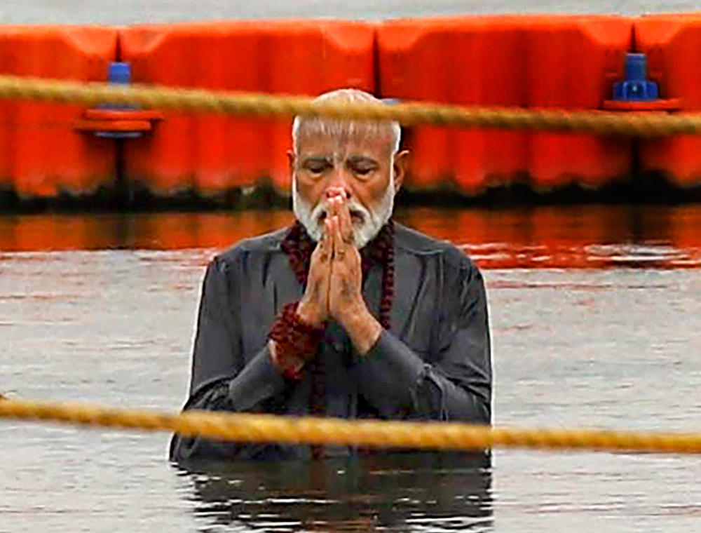 Narendra Modi takes a dip in the Ganga at Sangam during Kumbh Mela in Allahabad on Sunday.