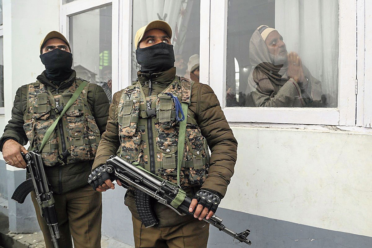 Security forces stand guard as Kashmiri Muslims pray in Srinagar on November  10, 2019.