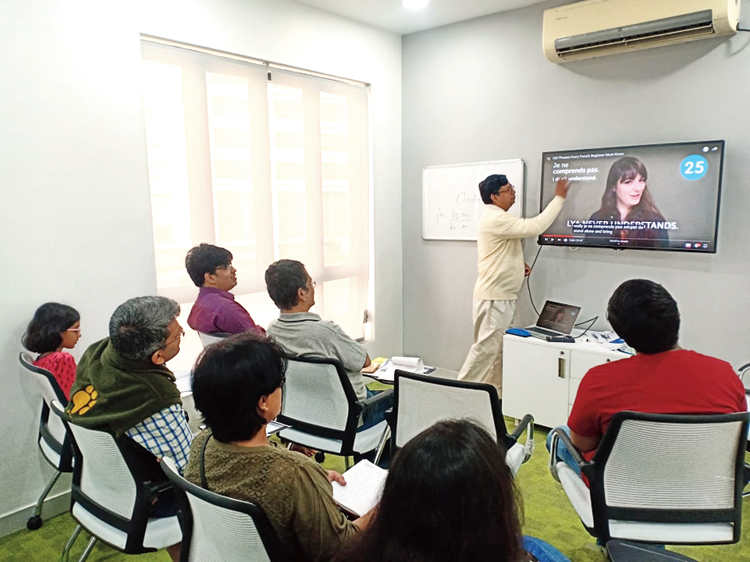 Debashis Sen takes a class in French language at New Town Library