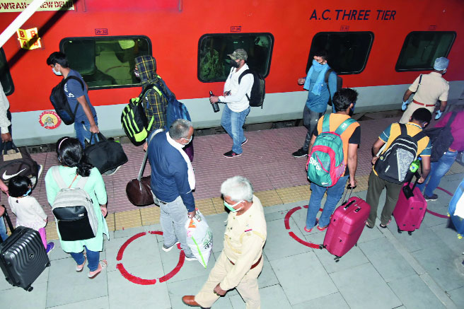 Passengers queue up to board the special train that reached Dhanbad from Howrah on Tuesday. 