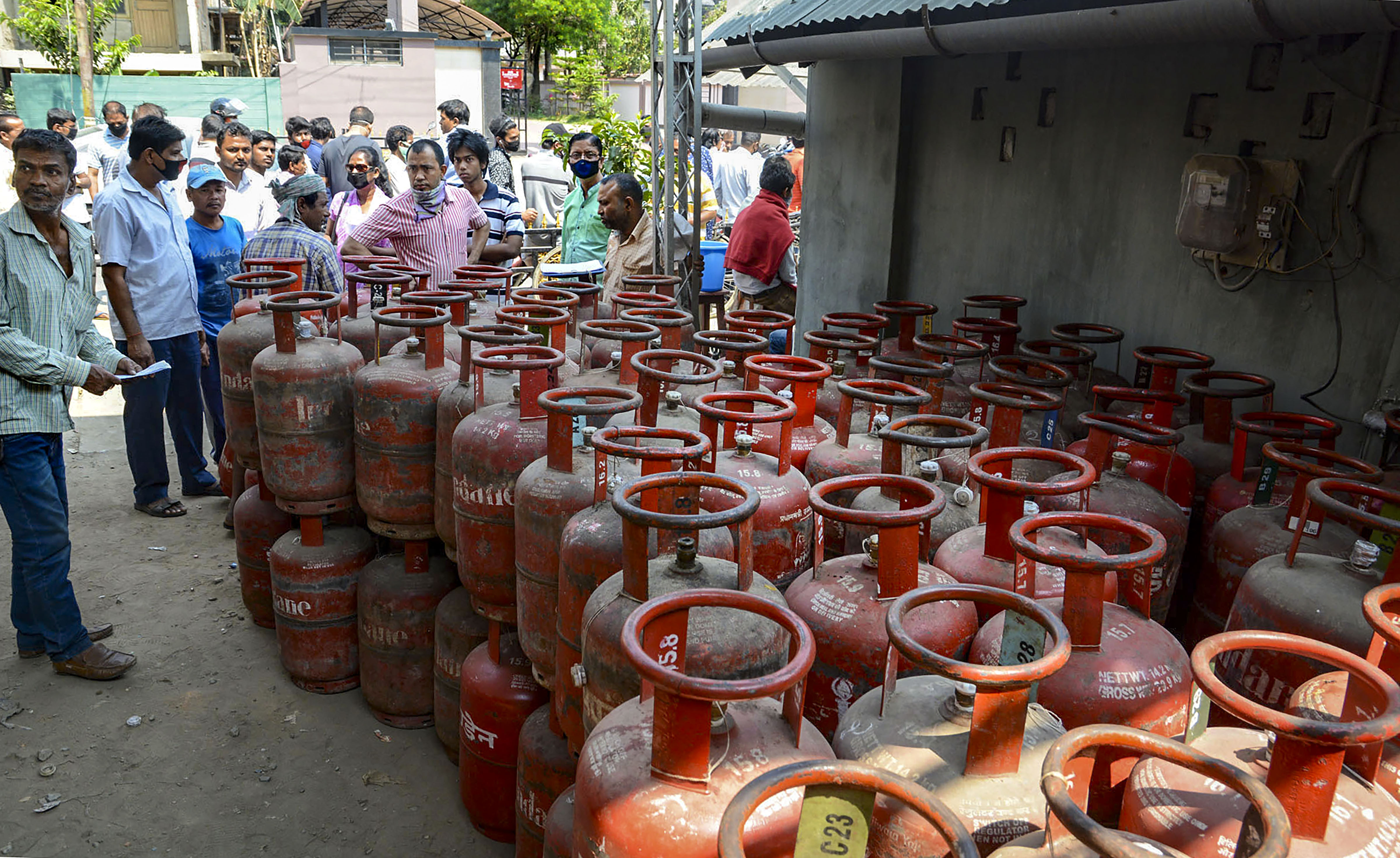 Locals gather to collect LPG cylinder after lockdown as a precautionary measure against coronavirus pandemic, at Uzan Bazaar in Guwahati, Tuesday, march 24, 2020