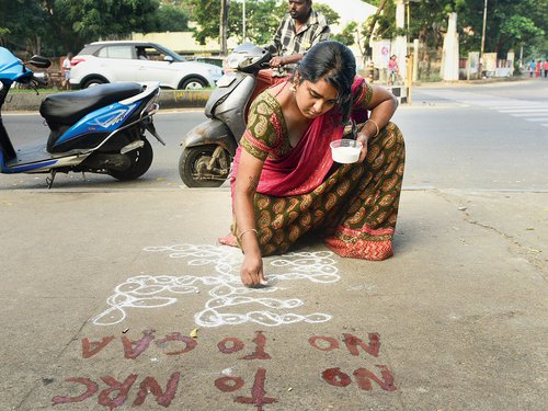 A protester writes a message, “No to NRC, No to CAA”, on a pavement in Chennai on Sunday.