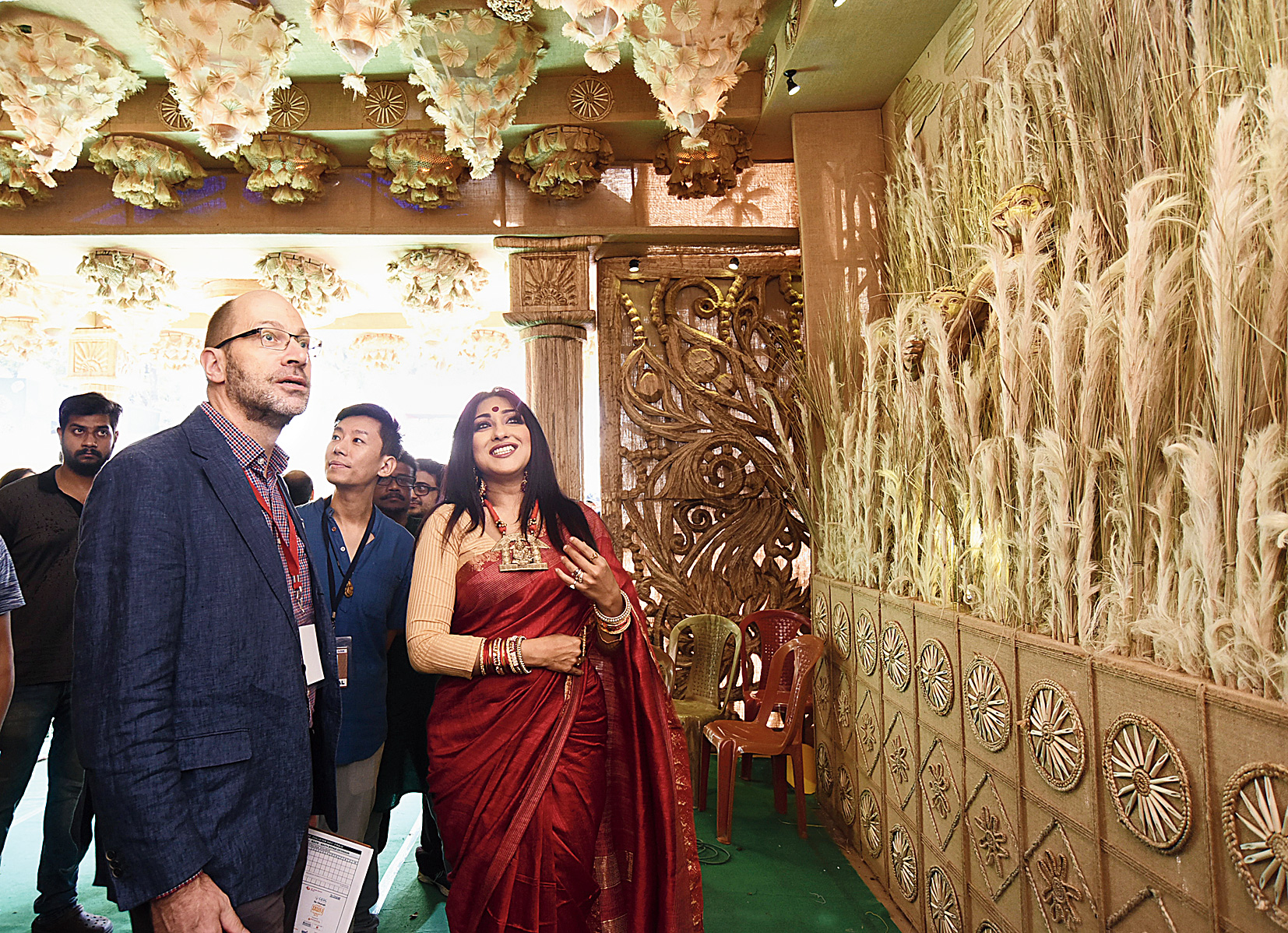 Rituparna Sengupta explains a scene from Pather Panchali, recreated in jute at the Jodhpur Park puja, to Michael Feiner.