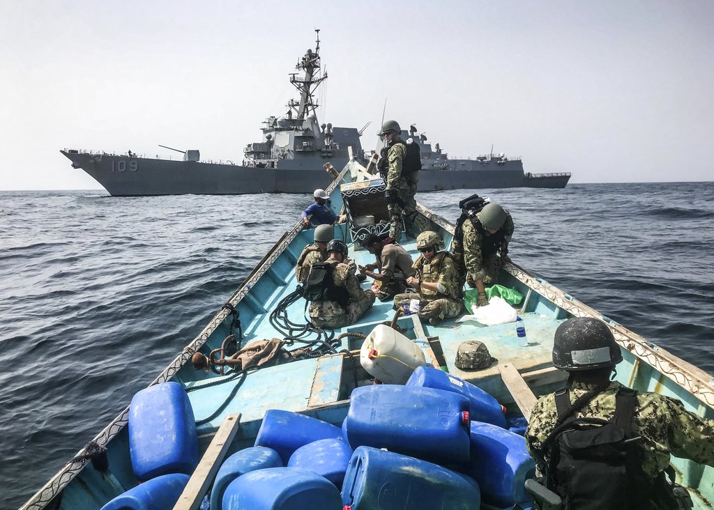 A team from the guided-missile destroyer USS Jason Dunham inspects a dhow while conducting maritime security operations.