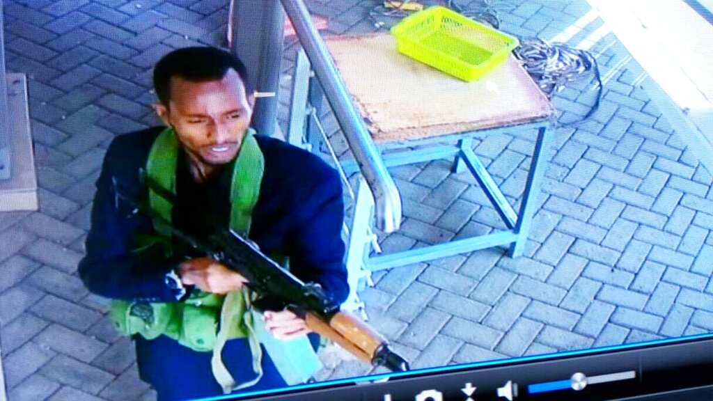 In this grab taken from security camera footage released to the local media, an armed attacker walks in the compound of the hotel in Nairobi on Tuesday.
