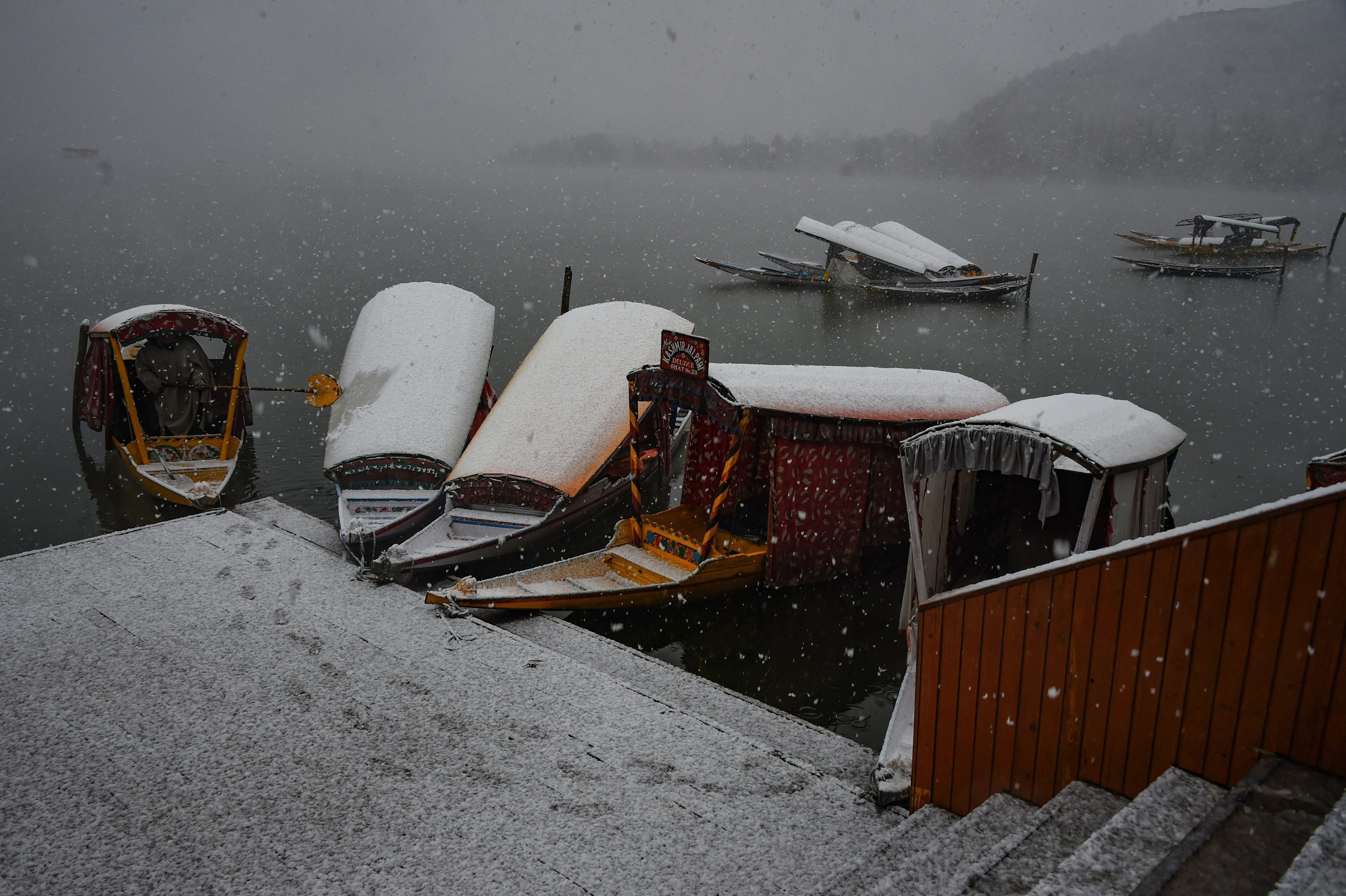 Shikaras covered in snow in Srinagar.