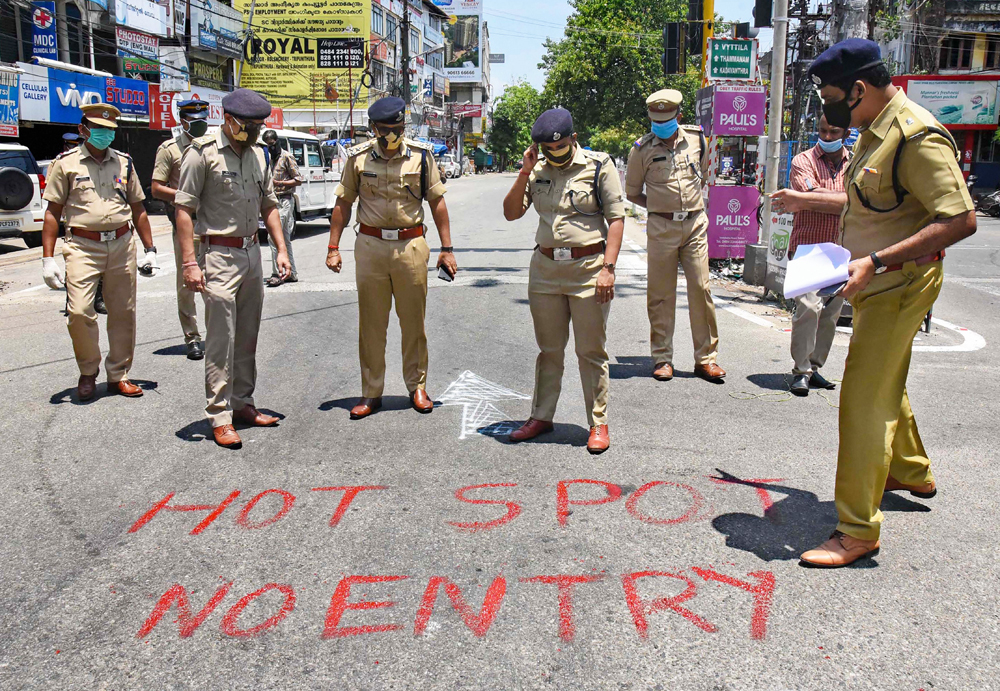 Police personnel mark a locality of Kaloor - Kathrikadavu as a Covid-19 hotspot, following emergence of positive patients, during the nationwide lockdown to curb the spread of coronavirus, in Kochi, Thursday, April 23, 2020.
