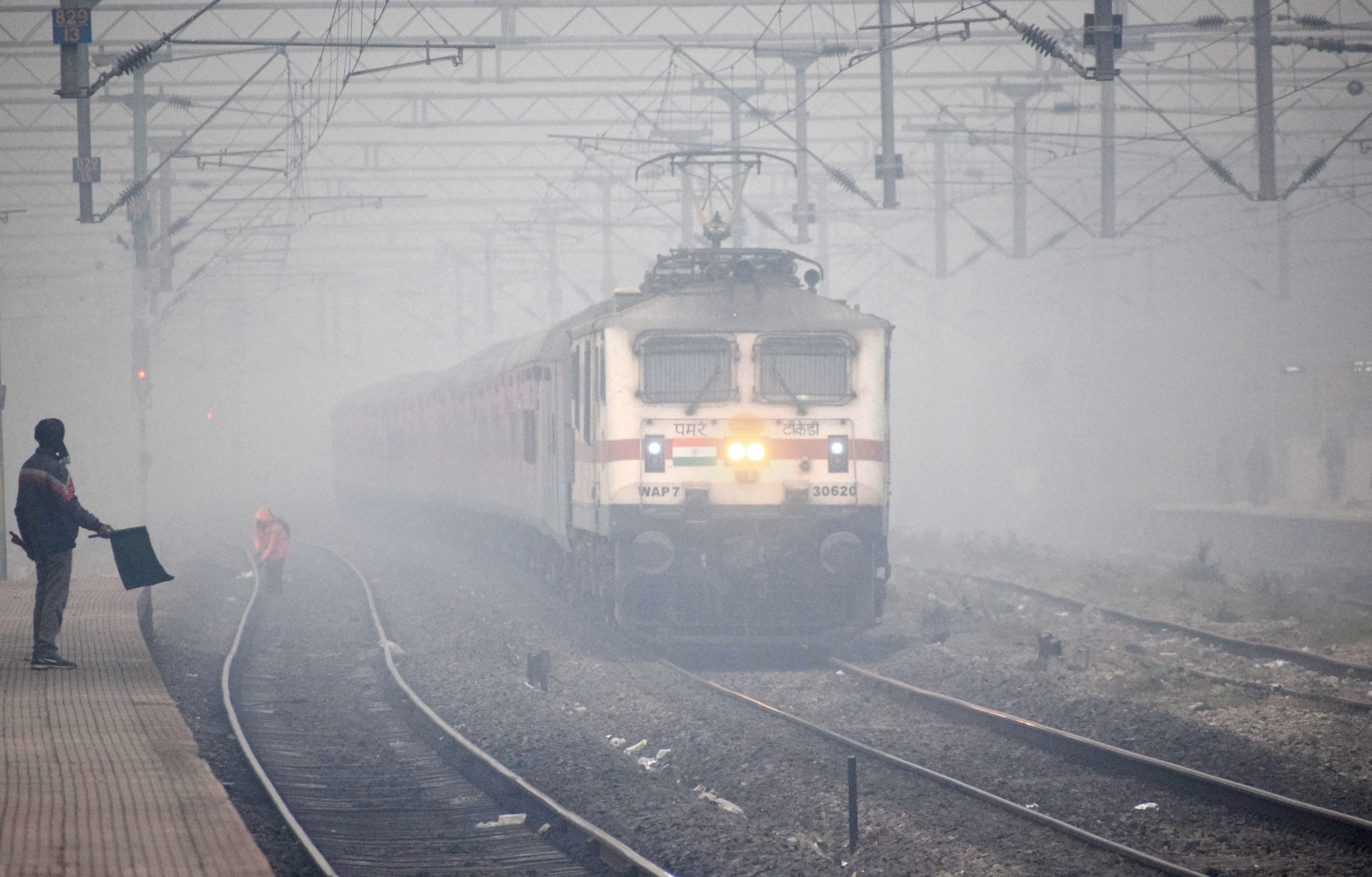 A train runs through fog on a cold winter morning, in Prayagraj, Saturday, December 7, 2019.