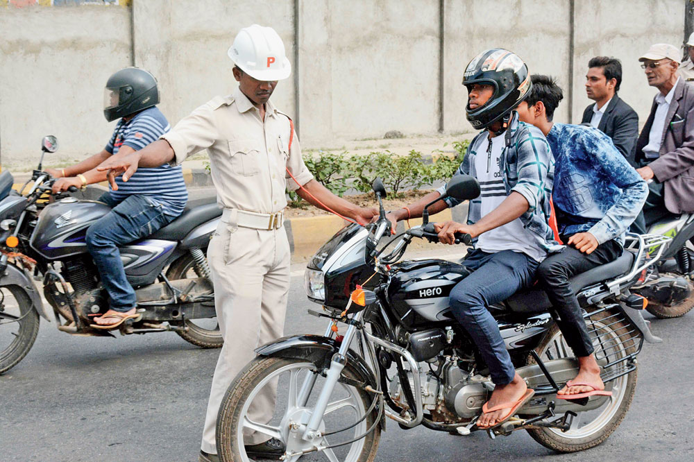 Policemen crack down on road safety offenders in Jugsalai, Jamshedpur, on Tuesday.