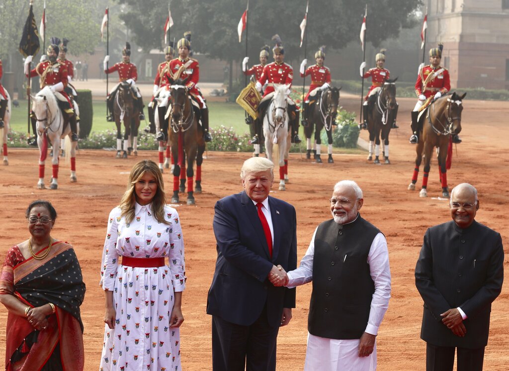 Prime Minister Narendra Modi shakes hand with US President Donald Trump, with first lady Melania Trump, second left, Indian President Ram Nath Kovind, right, and his wife Savita Kovind standing beside them during a ceremonial welcome for Trump at the Indian Presidential Palace in New Delhi