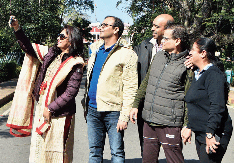 Rakesh Kumar (in black jacket), Dheeraj Kumar Arora (in dark green jacket) and Mohit Agarwal (in cream jacket) with their wives, click selfies, on the IIT(ISM) campus in Dhanbad on Sunday. 