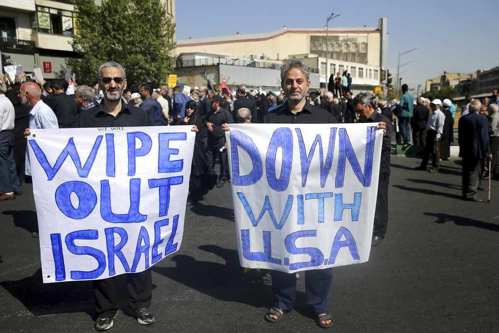 Two men hold up anti-American and anti-Israeli placards in a rally in Tehran on Friday.