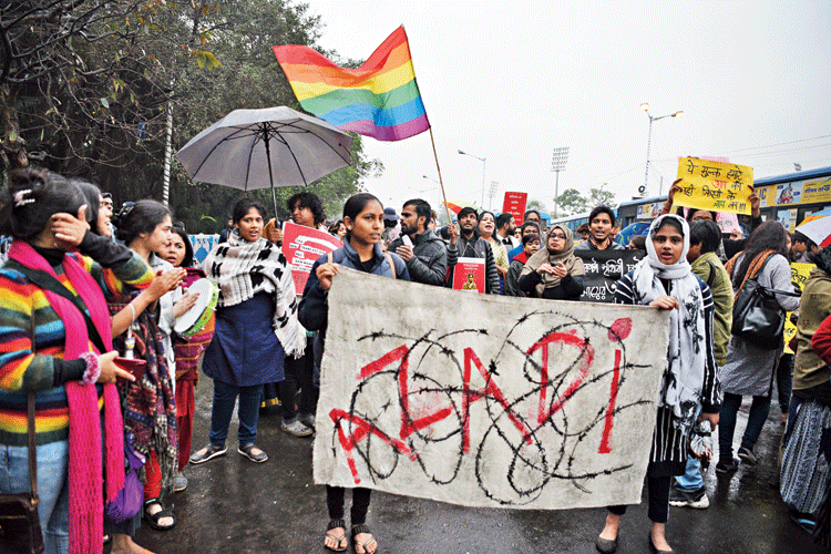 A protester holds an “Azadi” poster at the rally.