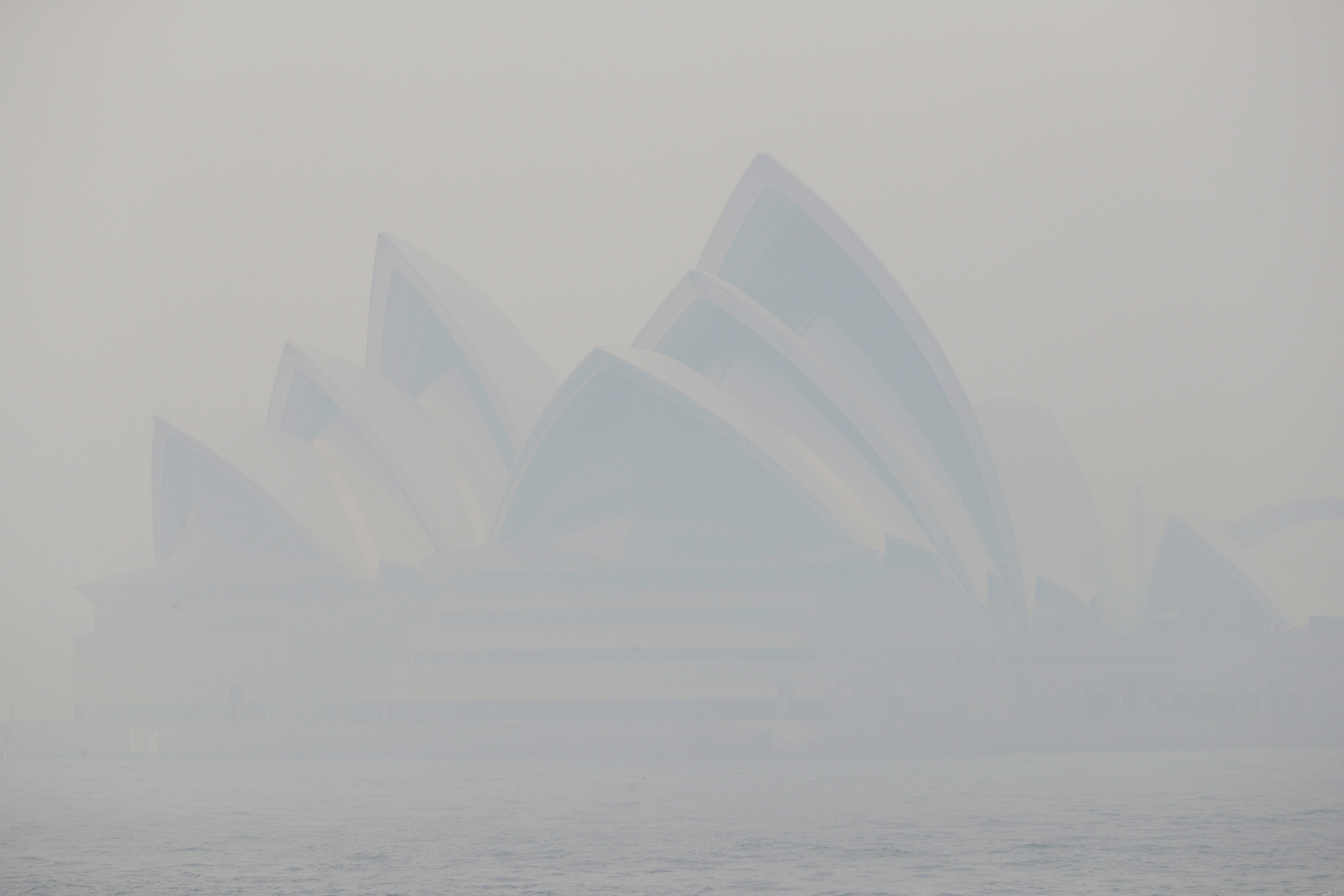 Thick smoke from wildfires shroud the Opera House in Sydney on December 10