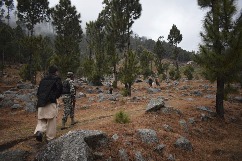 Pakistani reporters and troops visit the site of an Indian air strike in Jaba, near Balakot, Pakistan on Tuesday, February 26, 2019.