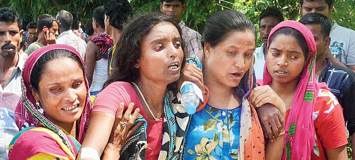 Relatives mourn in Rupahi Khatorgaon