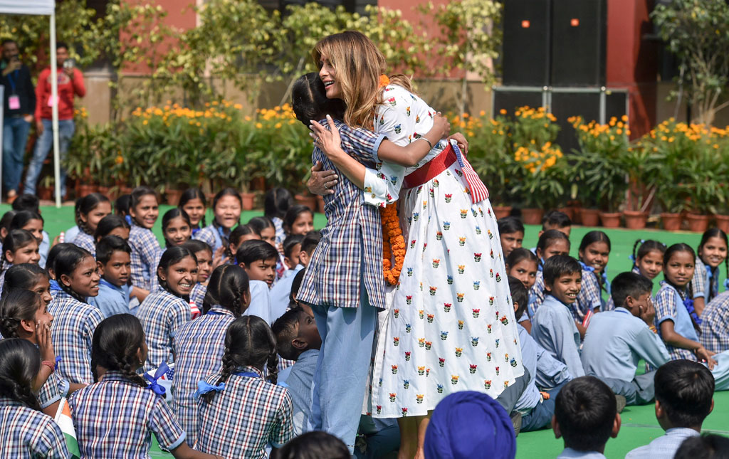 US First Lady Melania Trump hugs a school girl as she witnesses a happiness class, during her visit to a government school in New Delhi, Tuesday