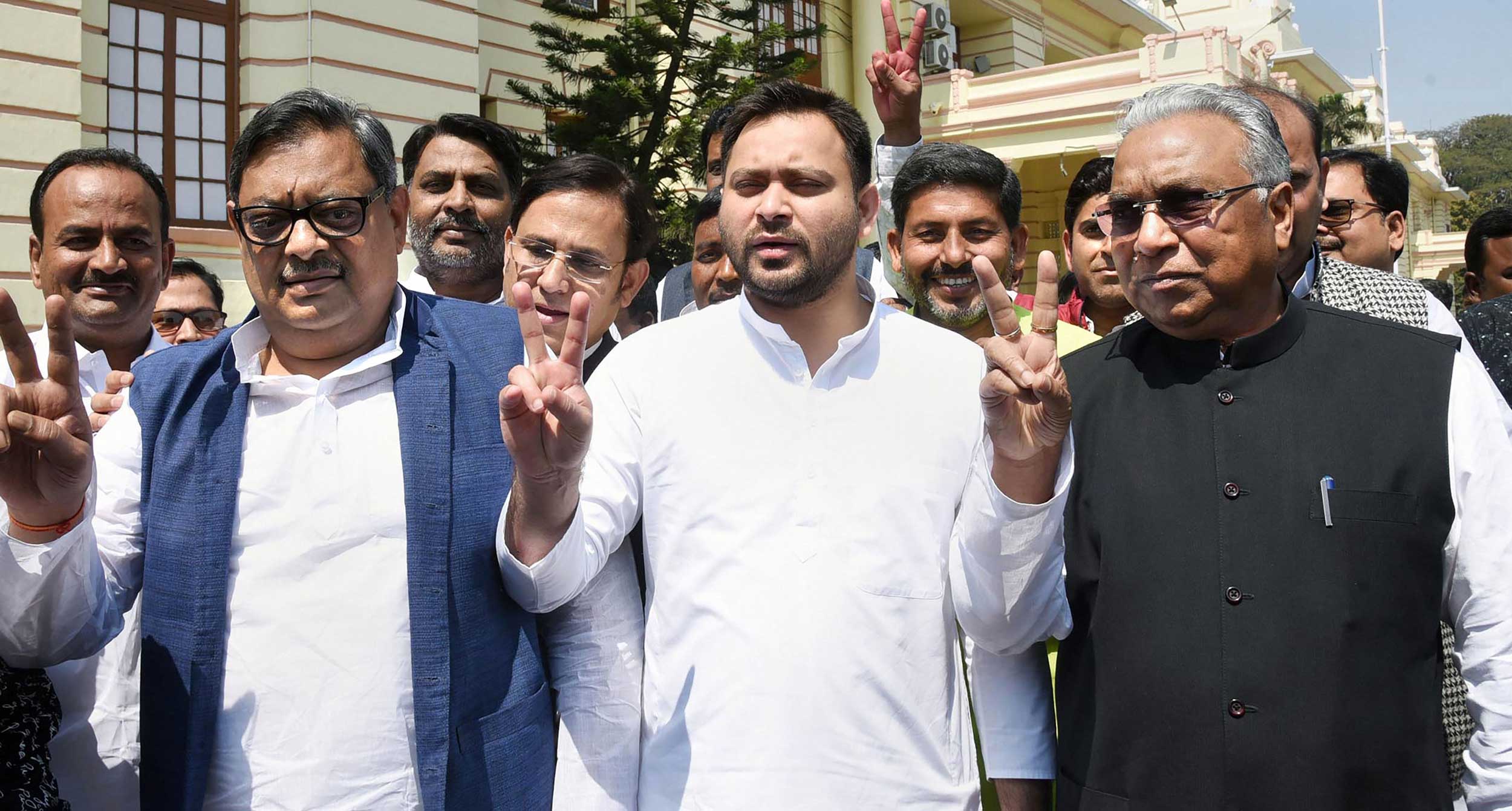 RJD candidates Prem Chand Gupta (right) and Amarendra Dhari Singh (left) with party leader Tejashwi Prasad Yadav flash victory sign after filing their nominations for Rajya Sabha elections, at Bihar Legislative Assembly in Patna, on Thursday.