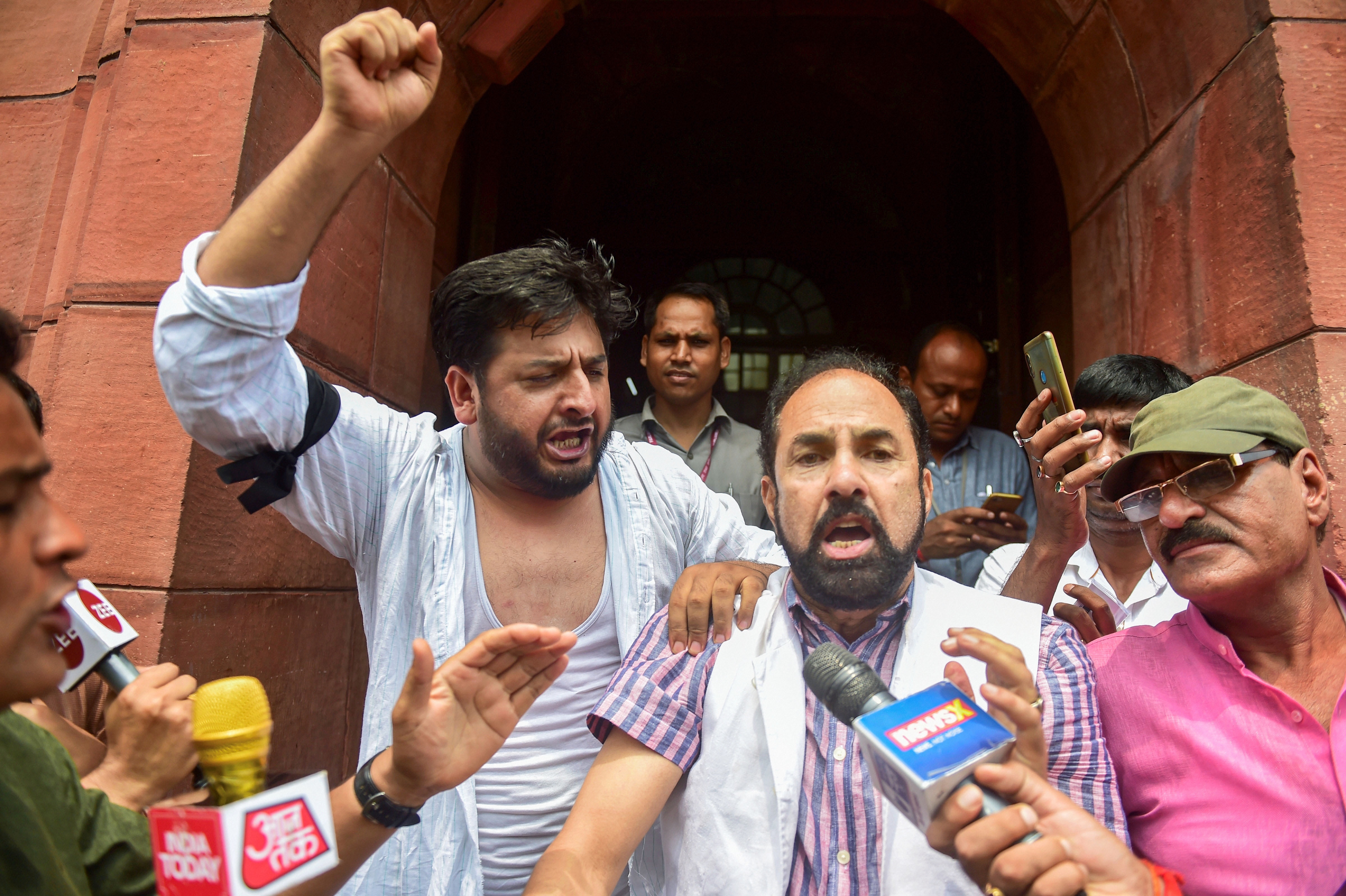 PDP MPs from Jammu and Kashmir, Fayaz Ahmad Mir and Nazir Ahmad Laway, shout slogans during a protest outside Parliament on August 5.
