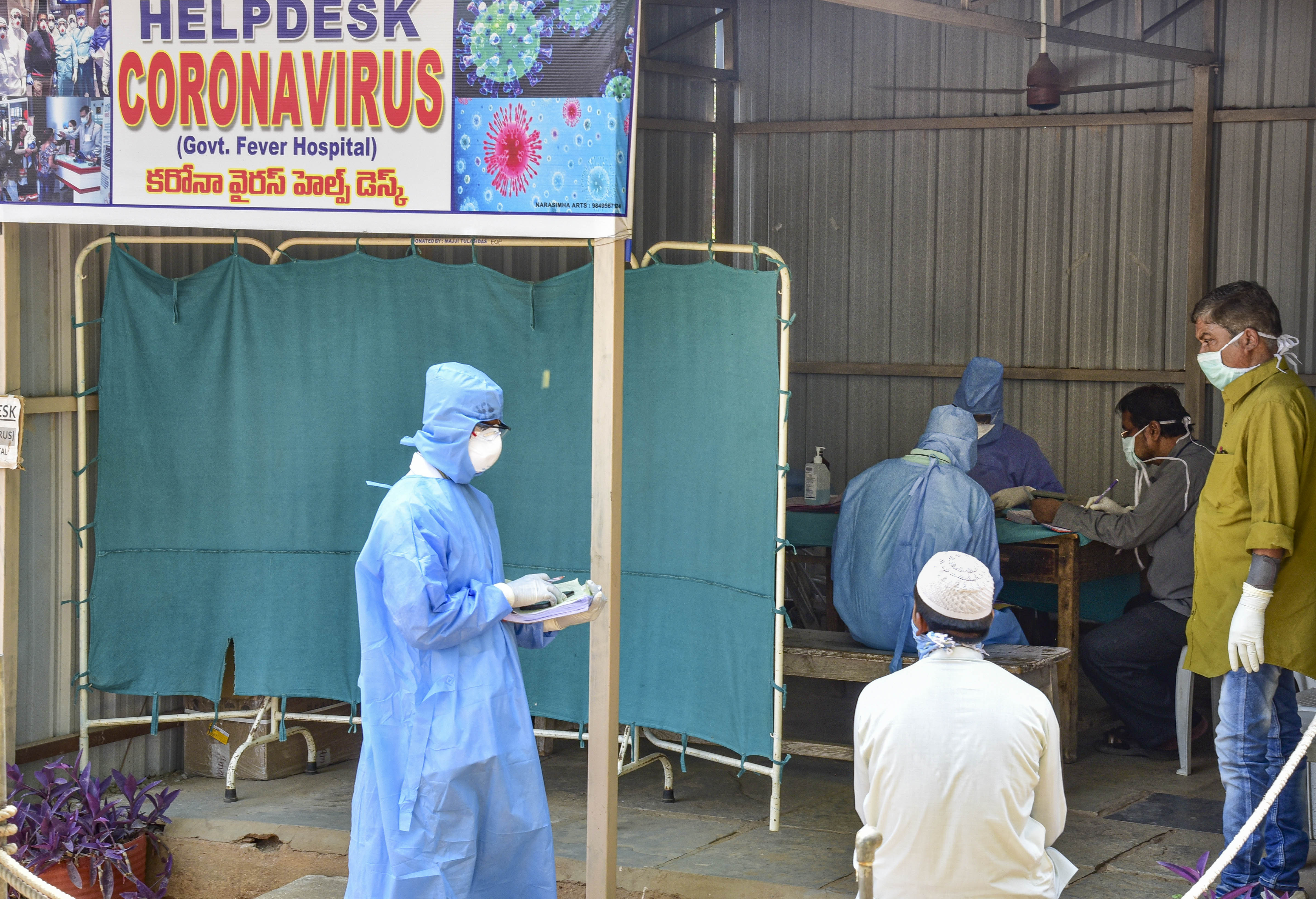 Medics examine patients for COVID 19 during a nationwide lockdown in the wake of the disease, in Hyderabad, Wednesday, April 1, 2020.