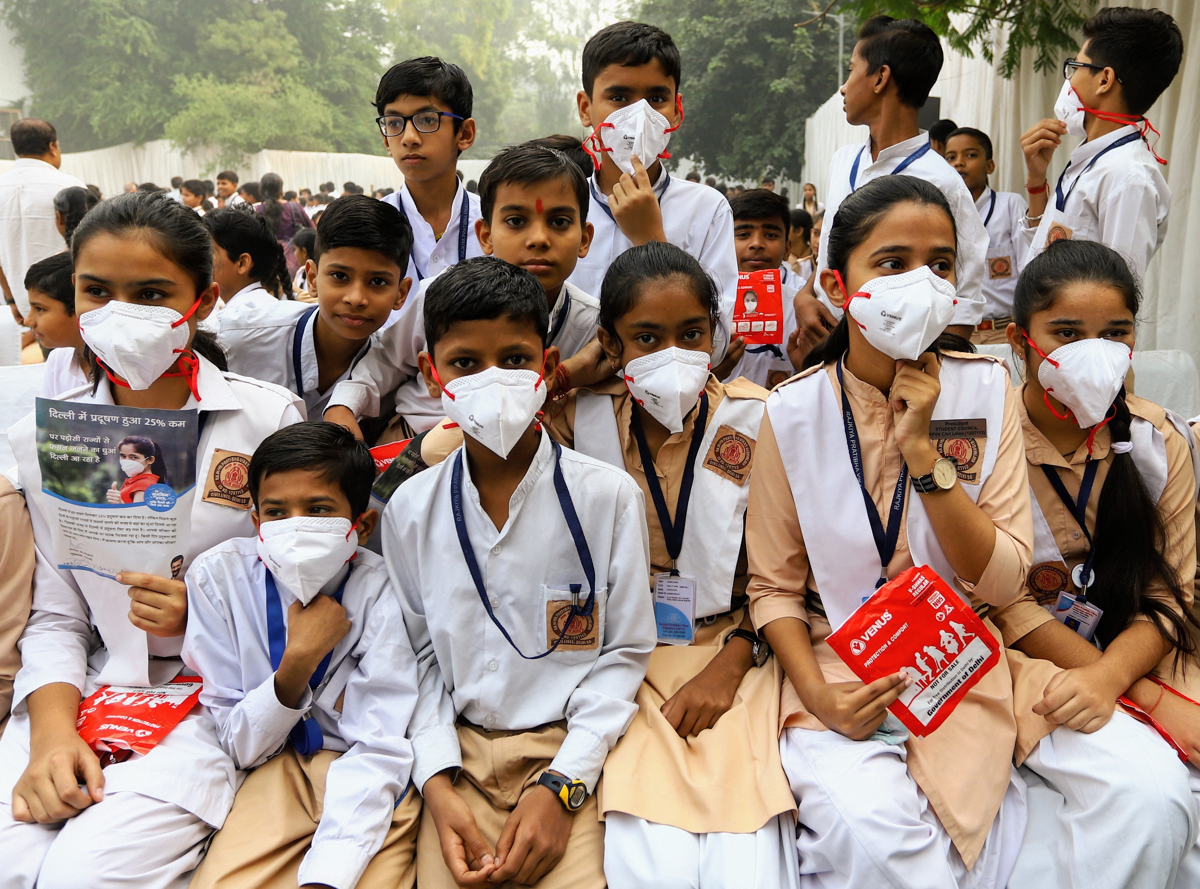 Student after receiving anti-pollution masks from Delhi chief minister Arvind Kejriwal at Rajkiya Pratibha Vikas Vidyalaya, in New Delhi, Friday, November 1, 2019.