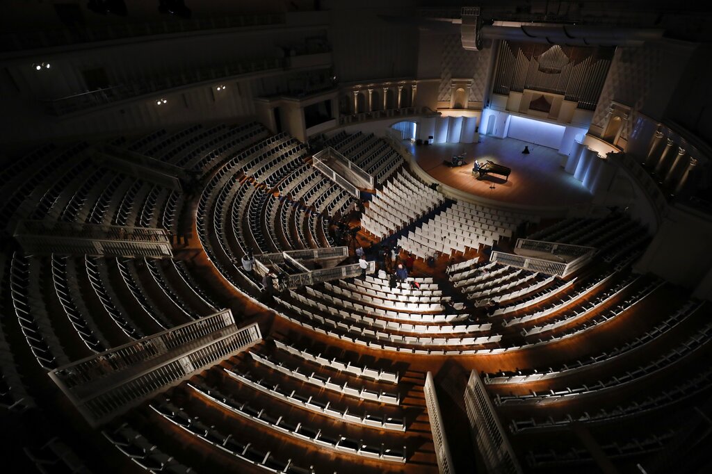 Russian pianist Denis Matsuyev performs on a stage at Tchaikovsky Concert Hall while preparing for an online broadcast, during a rehearsal in Moscow, Russia, Friday, March 20, 2020. A concert without an audience will be aired live online as a precaution against the new coronavirus.