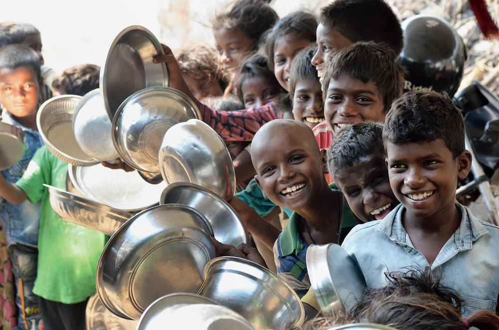 Grins in grim times: Children of coal workers queue up for free food outside a Mukhyamantri Dal Bhat Kendra at Kujama in Jharia, Dhanbad, on Saturday. The Dal-Bhat kitchens apart, the state government has also set up Didi kitchens across panchayats. Recently, the state also set up around 100 Didi kitchens near national highways so that returning migrants don’t go hungry