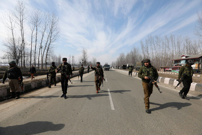 Indian police and paramilitary soldiers block a road leading towards the site of a brief gun-battle with suspected rebels on the outskirts of Srinagar, on Wednesday