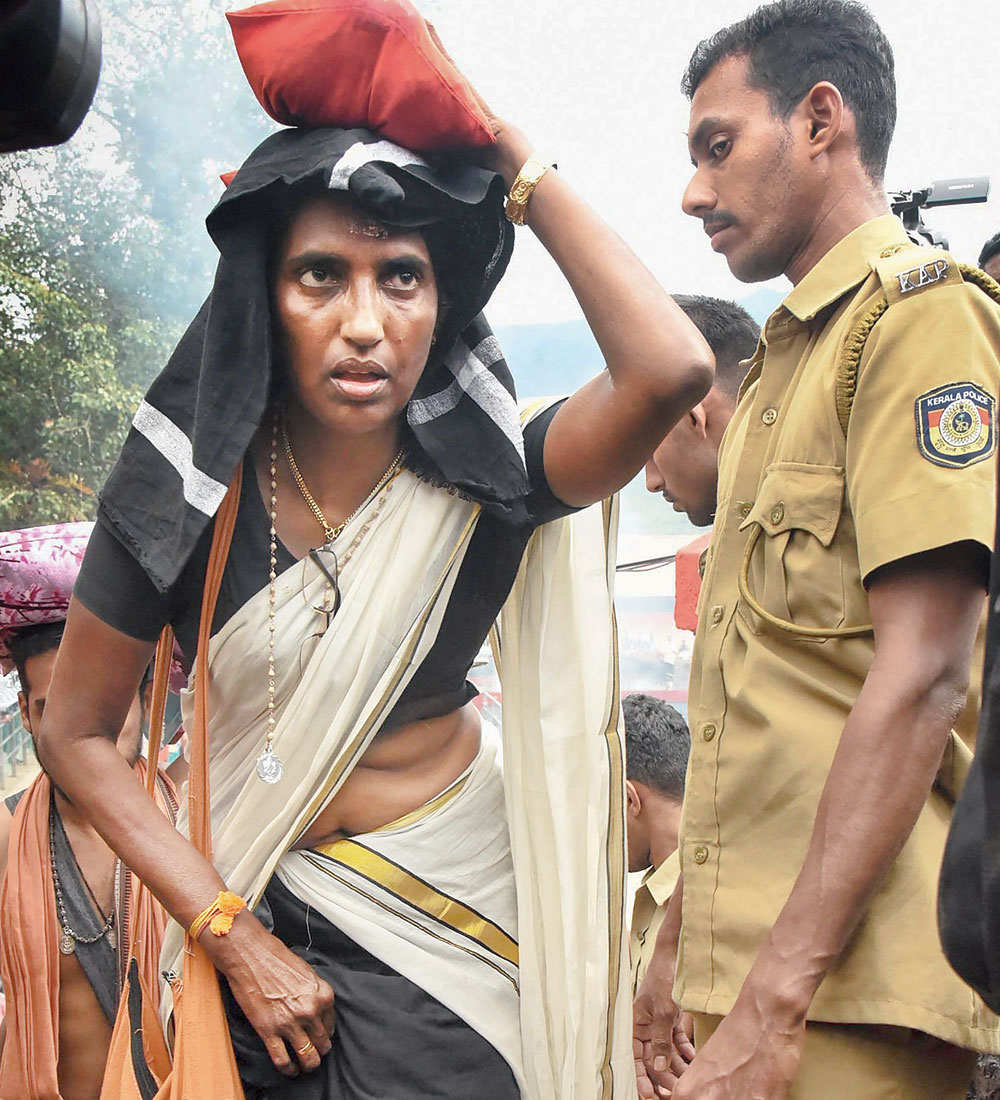 Hindu Aikya Vedi leader KP Sasikala, who was arrested last week and released on bail, climbs the 18 sacred steps to offer prayers at the Sabarimala temple on Monday