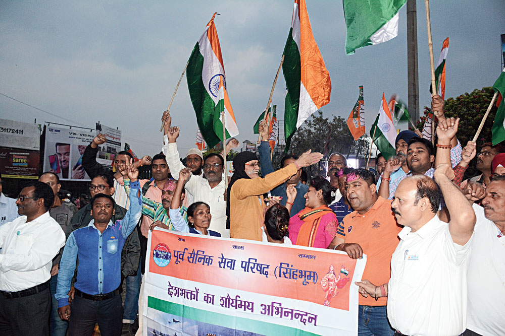 Former servicemen celebrate the IAF strike with gulal at Sakchi roundabout in Jamshedpur