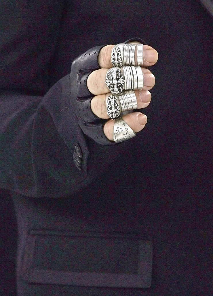 This January 25, 2005 file photo, shows Lagerfeld's hand, seen backstage before the presentation of the spring-summer 2005 haute couture fashion collection he designed for Chanel. The love of his life, his cat Choupette, was testament to his kind, if eccentric, heart. He wore her likeness as a pendant at one show and acknowledged that she has at least two maids. She is spoiled, "much more than a child could be," he said in 2013, revealing that he took her to the vet nearly every 10 days. Like a proud parent, Lagerfeld told a magazine that Choupette earned more than $3 million in 2014 for advertising campaigns.
