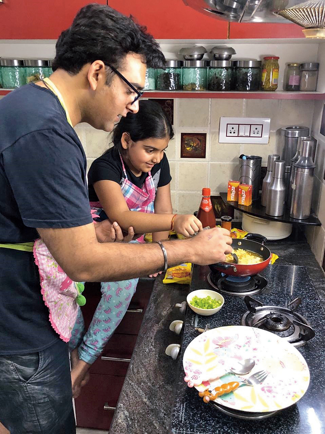 Little Chitrangana is picking up cooking skills from dad Rohan.