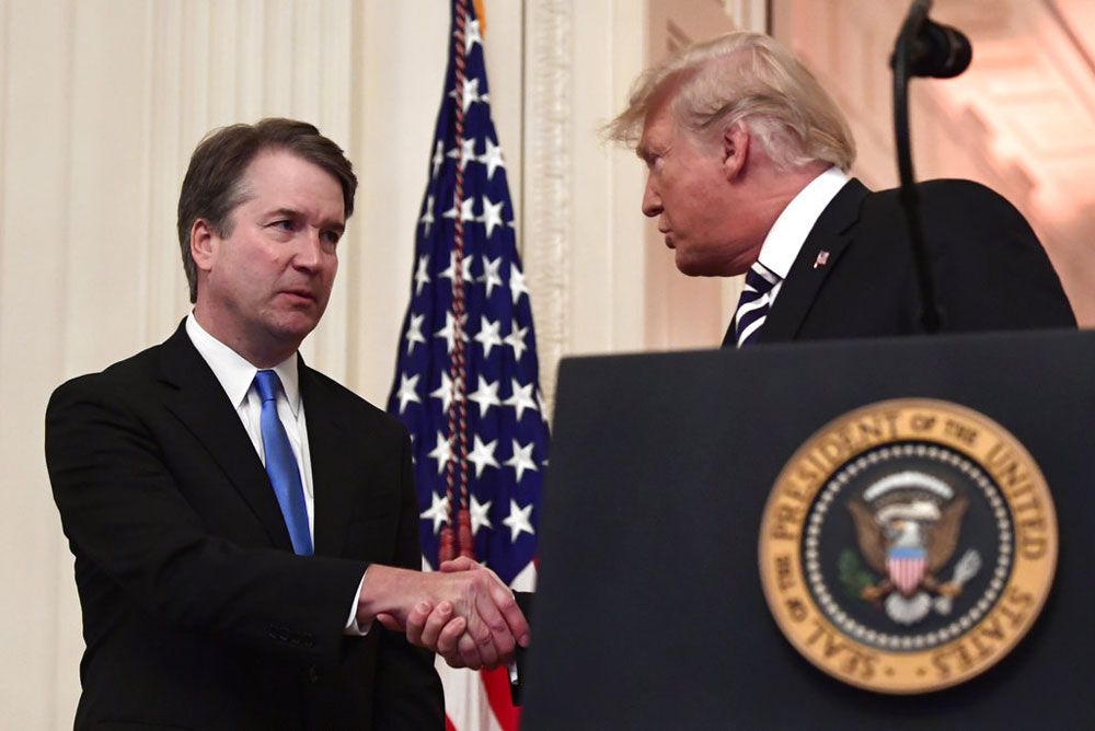 President Donald Trump shakes hands with Supreme Court Justice Brett Kavanaugh