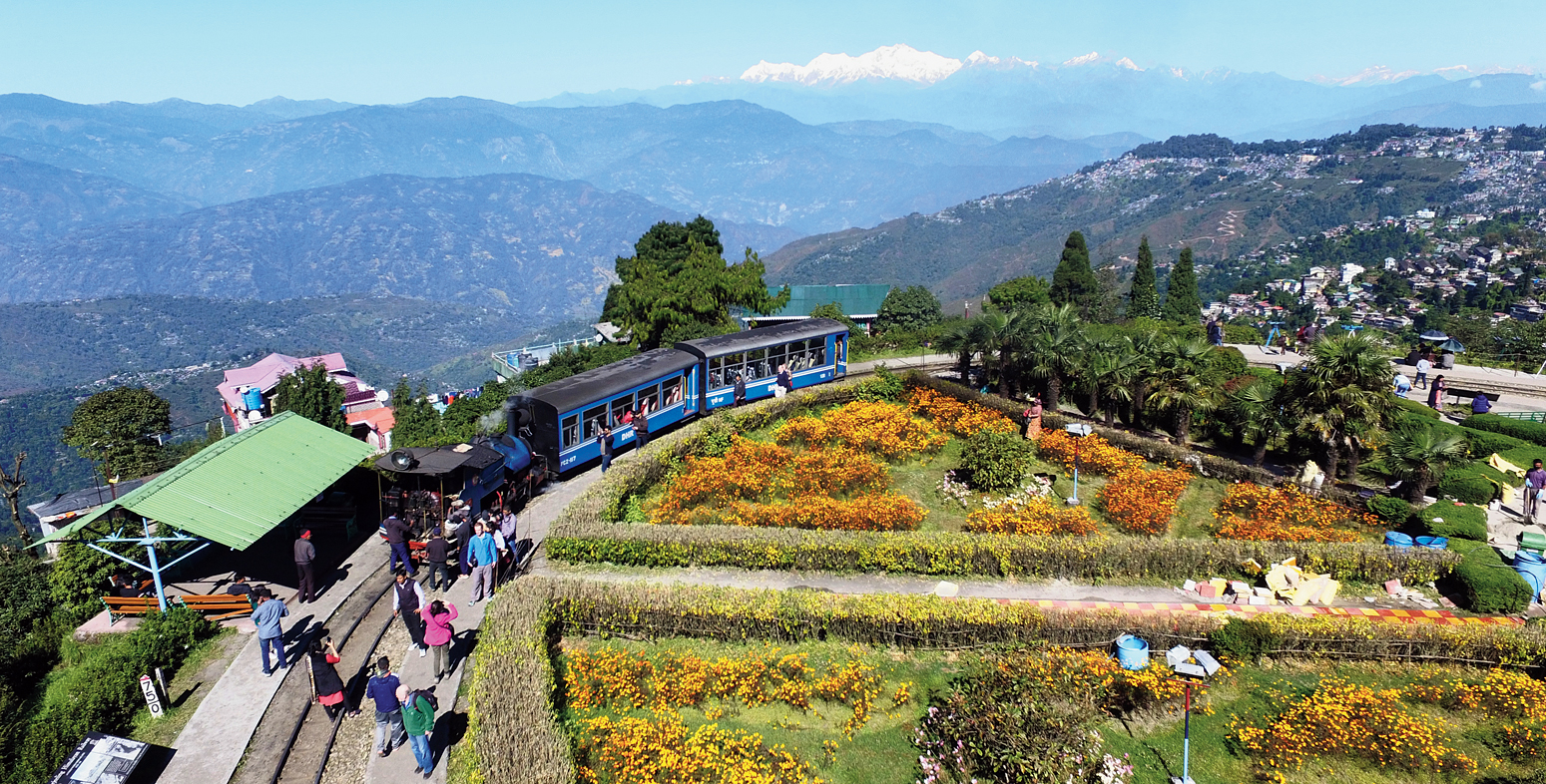 A toy train passes through Batasia Loop in Darjeeling