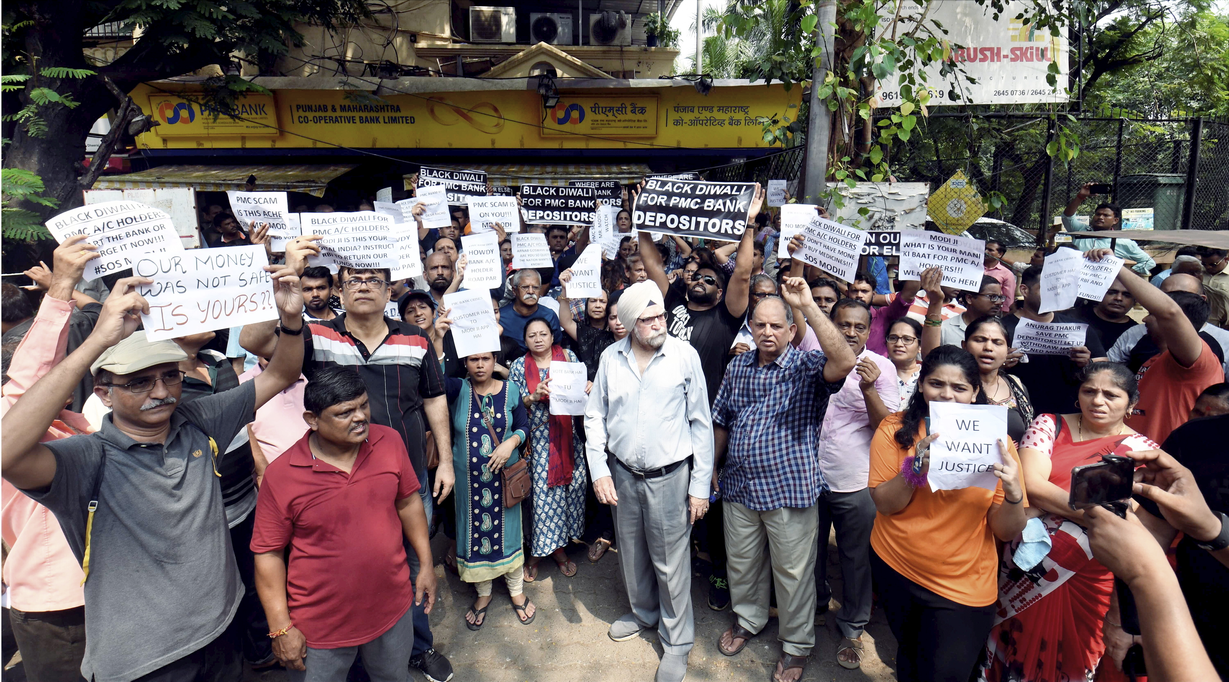 Depositors of Punjab and Maharashtra Cooperative Bank stage a protest over the banks crisis, outside a bank branch in Andheri, Mumbai, Wednesday, October 2, 2019.