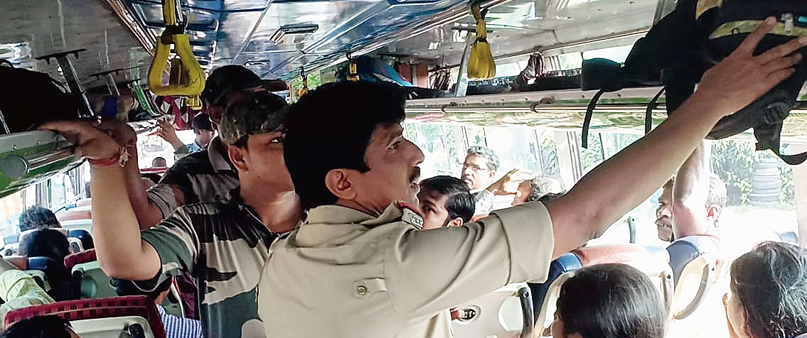 Police check a bus for explosives after Thursday’s escape bid by Bera in which he used bombs supplied by an accomplice.