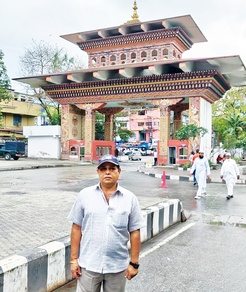 Ajay Sharma against the backdrop of the Bhutan Gate in Phuentsholing.