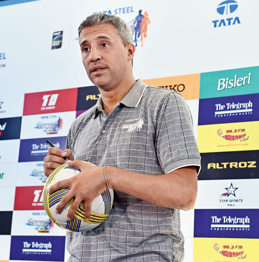 Hernan Crespo signs a football during the Tata Steel Kolkata 25K media conference on Friday
