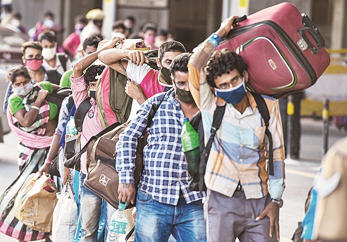 Migrants stand in a queue at Central Railway Station to board a Shramik Special train for West Bengal, during Covid-19 lockdown, in Chennai, Wednesday, June 3, 2020. 