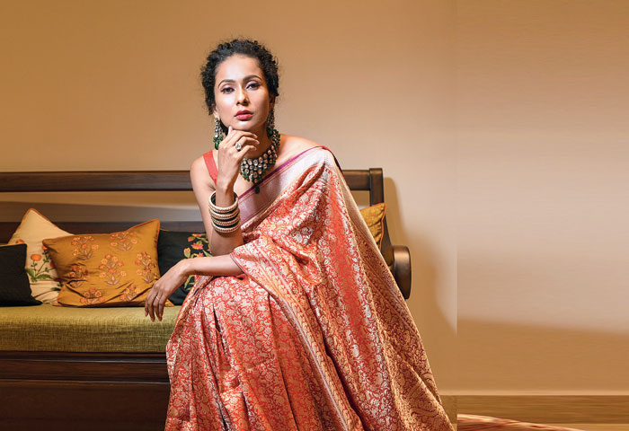 Elegant is this scarlet Benarasi with intricate design detailing on kadhwa weave. The gold and silver zari brings alive the traditional shikargarh motifs. The look is accessorised with traditional kundan and emerald earrings and neckpiece. “The rich red Benarasi is the quintessential regal weave. Though the sari has heavy work, it has a weave that settles softly against the skin,” said Shreevatsa.