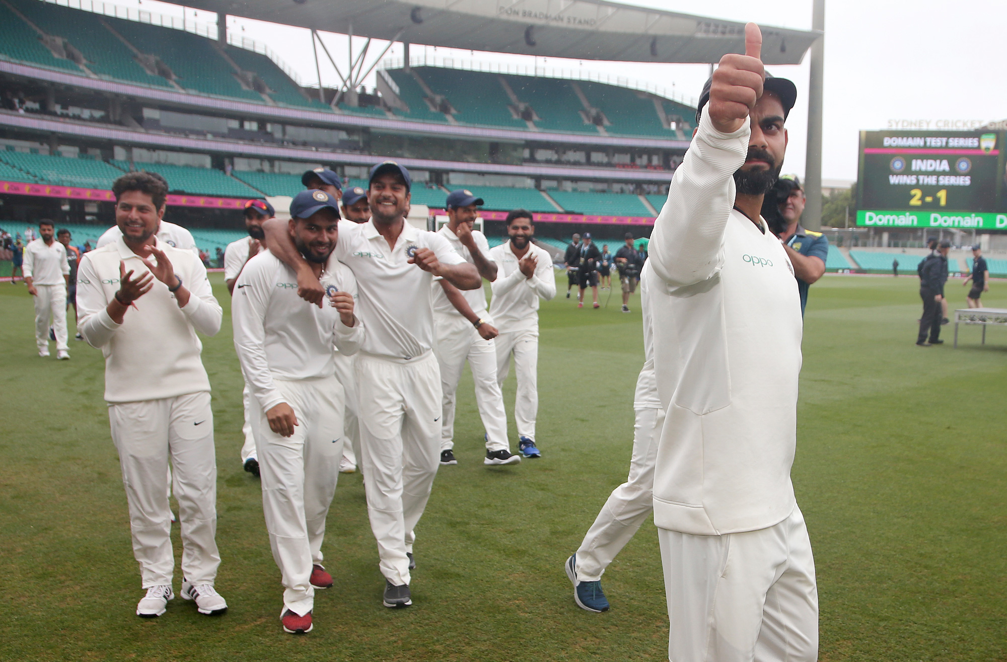 Captain Virat Kohli, right, celebrates with teammates after India's series win when play was called off on day 5 of their cricket test match in Sydney, Monday, January 7. The match was a draw and India won the series 2-1.