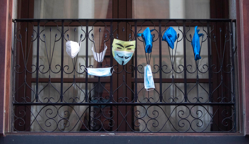 Face masks and gloves hang from a balcony in Madrid on Wednesday