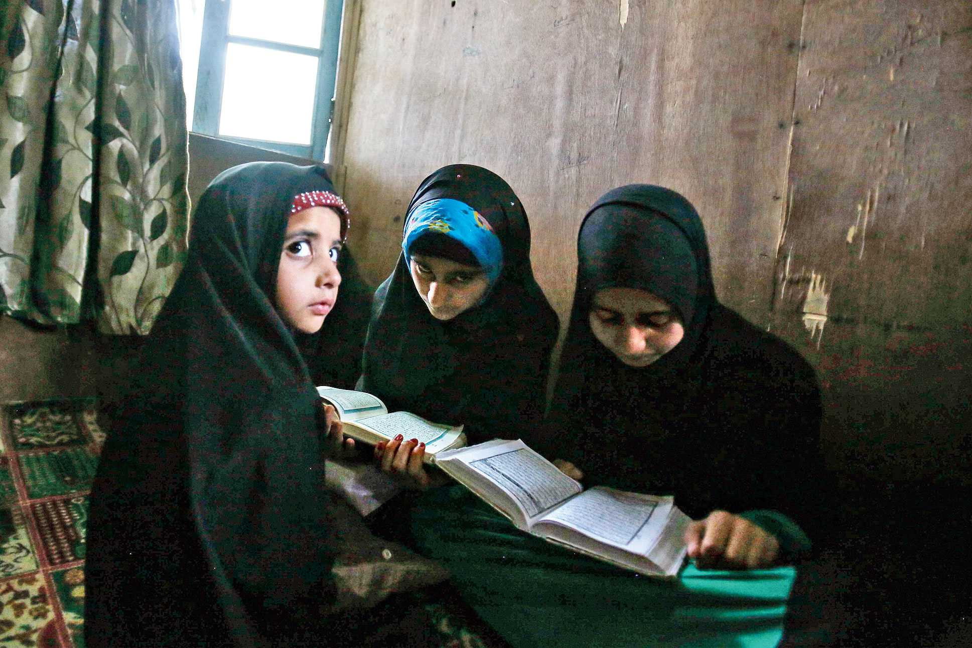 Kashmiri children attend recitation classes of the holy Quran on the 
first day of Ramazan in Srinagar on May 7, 2019.