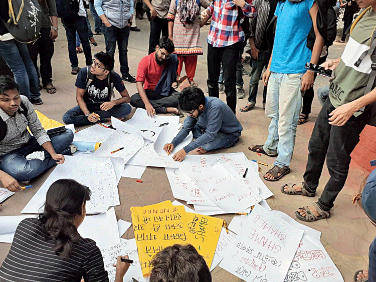 Students write posters on the Jadavpur University campus on Monday before taking part in a march to protest the Citizenship (Amendment) Act and show solidarity with students under attack in other parts of the country. 
